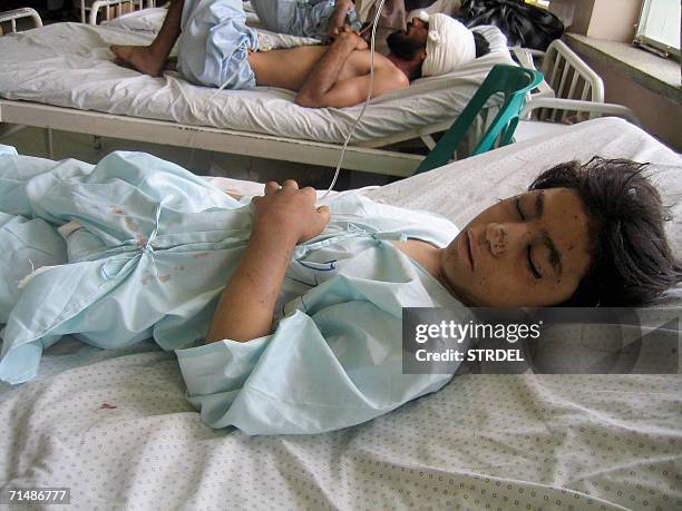 Wounded child, one of amongst seven people injured in an attack in the Mezan district, lies in the City Hospital in Khandahar, 20 July 2006. The...