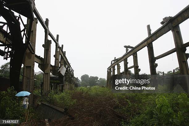 People visit the ruins of a factory of former Tangshan Locomotive & Rolling Stock Works, destroyed during the Tangshan Earthquake on July 16, 2006 in...