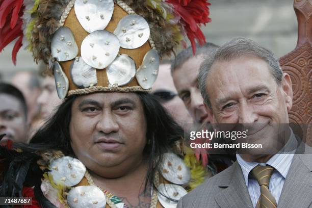 Paris Mayor, Bertrand Delanoe, stands beside a man in Tahitian attire as he opens 'Paris Plage' 2006 on July 20, 2006 in Paris, France. The Paris...