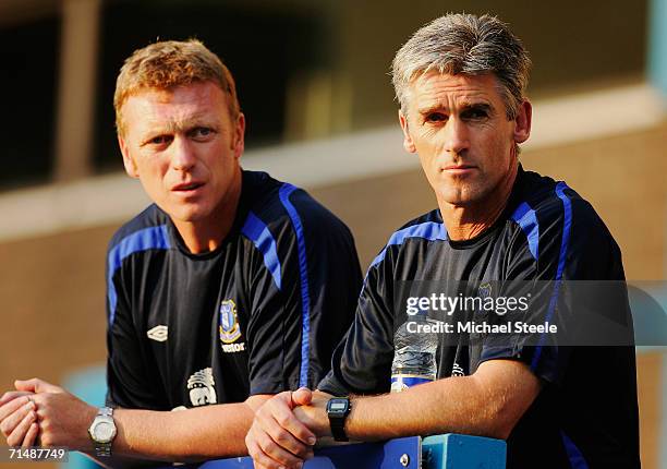 Alan Irvine the coach of Everton looks on with manager David Moyes during the friendly match between Preston North End and Everton at Deepdale on...