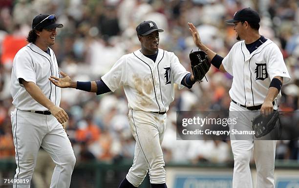Magglio Ordonez, Curtis Granderson and Alexis Gomes of the Detroit Tigers celebrate after defeating the Chicago White Sox 2-1 on July 20, 2006 at...