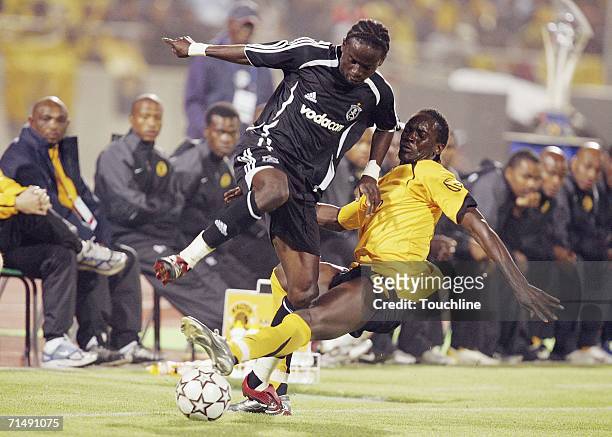 Tico Okonkwo of the Pirates is tackled by David Obua of the Chiefs during the pre-season friendly Vodacom Challenge match between Kaizer Chiefs and...