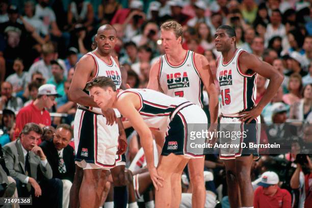 Charles Barkley, Christian Laettner, Larry Bird and Magic Johnson of the United States National Team discuss strategy during the1992 Summer Olympics...