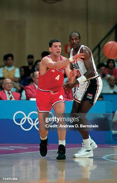 Clyde Drexler of the United States National Team digs in on defense against Drazen Petrovic of Croatia during the Gold Medal Game of the1992 Summer...