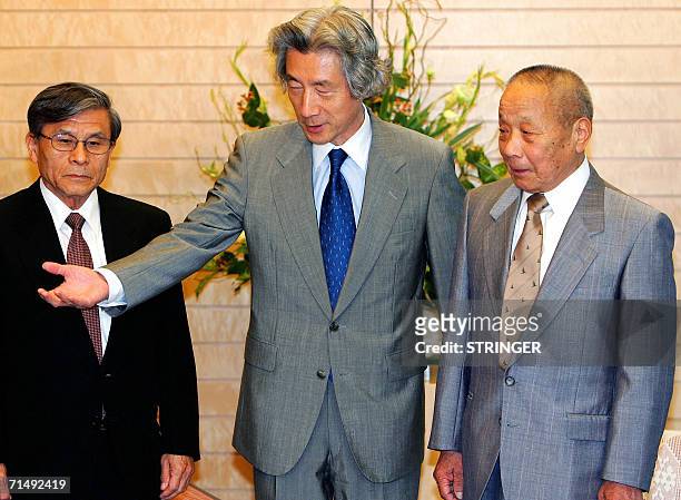 The representative of a group of Japanese emigrants to the Dominican Republic, Hitoshi Koichi, , is escorted by Japanese Prime Minister Junichiro...