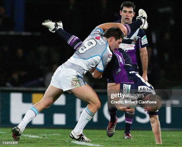 Michael Crocker of the Storm is tackled by Kevin Kingston of the Sharks during the round 20 NRL match between the Melbourne Storm and the Cronulla...