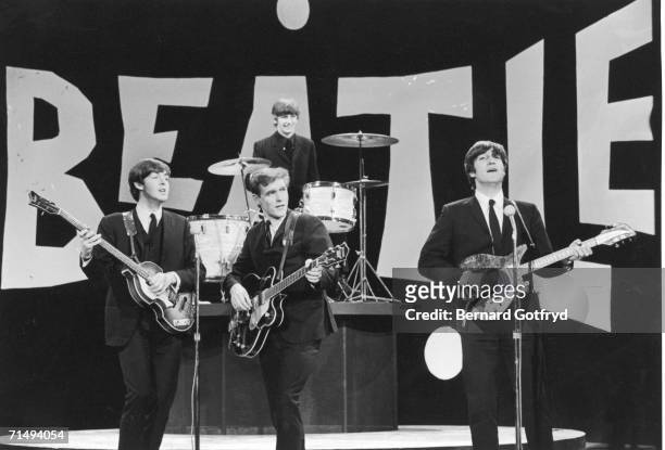 Members of British Rock group the Beatles perform on the set of 'The Ed Sullivan Show' at CBS's Studio 50, New York, New York, February 8, 1964....