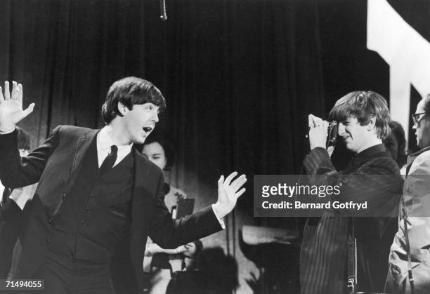 British Rock musicians Paul McCartney and Ringo Starr clown around on the set of 'The Ed Sullivan Show' at CBS's Studio 50, New York, New York,...