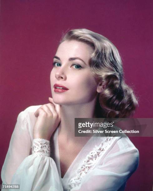 American actress Grace Kelly in a lace-trimmed top, circa 1955.