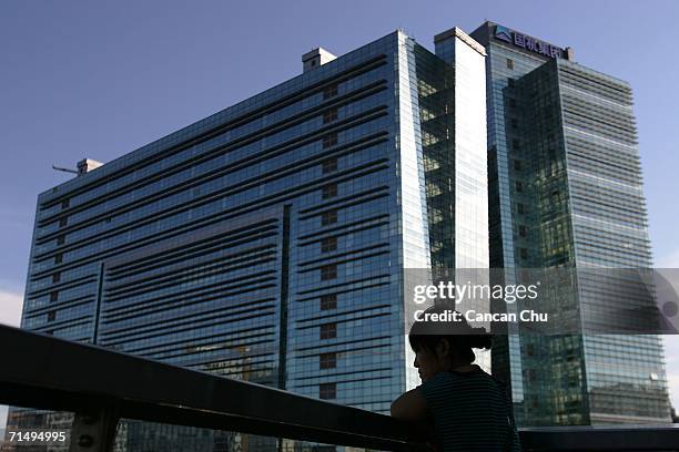 Chinese girl looks at the street view from a newly installed building at Zhongguancun Scientific and Technological Development Area, also known as...