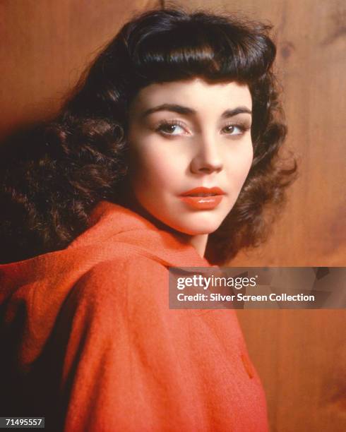 American actress Jennifer Jones wearing a red cape, circa 1945.