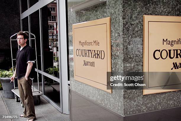 Man smokes a cigarette outside a Marriott Courtyard hotel near the Magnificent Mile shopping district July 21, 2006 in Chicago, Illinois. Beginning...