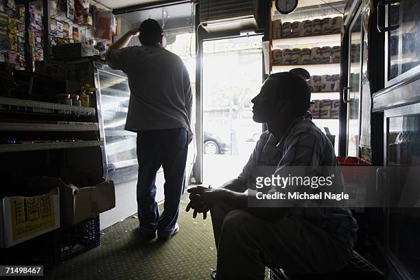 Sheikh M. Istaque Ahmed sits in Wahid & Brothers Inc. During a blackout in the neighborhood of Astoria July 21, 2005 in the Queens borough of New...