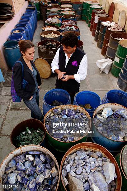 French Jeweler designer Marie Helene De Taillac with Jeweller Munnu Kasliwal the owner of Gem Palace looking at barrels of precious and semi-precious...