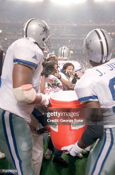 Defensive end Leon Lett and defensive tackle Jimmie Jones of the Dallas Cowboys prepare for the victory celebration with the traditional Gatorade...