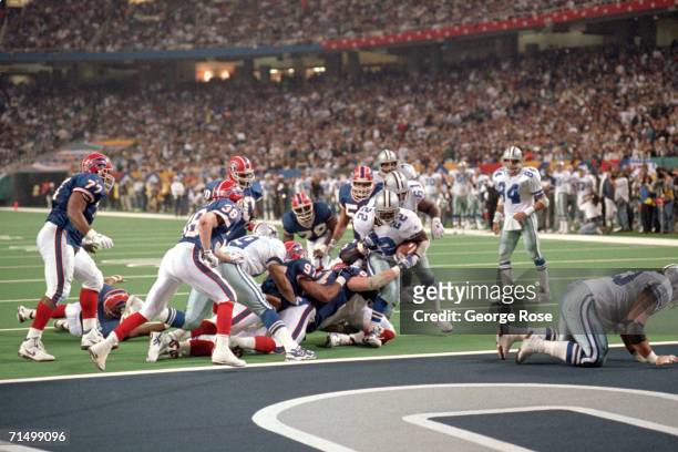 Running back Emmitt Smith of the Dallas Cowboys scores a one yard touchdown with 9:50 left of the clock putting Dallas up 27-13 in the fourth quarter...