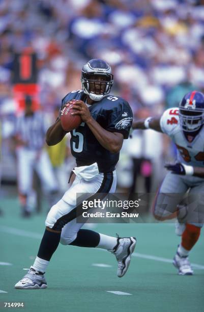 Donovan McNabb of the Philadelphia Eagles looks to pass the ball during the game against the the New York Giants at the Veterans Stadium in...