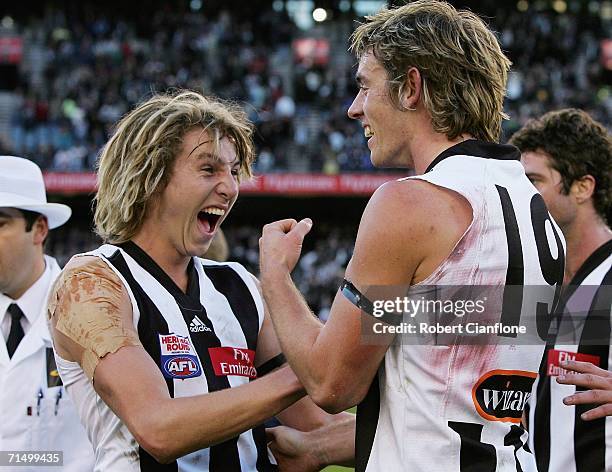 Dale Thomas and Ben Davis of the Magpies celebrate the Magpies win over the Eagles after the round 16 AFL match between the Collingwood Magpies and...