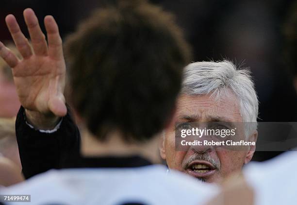 Michael Malthouse coach of the Magpies talks to his players at the break during the round 16 AFL match between the Collingwood Magpies and the West...