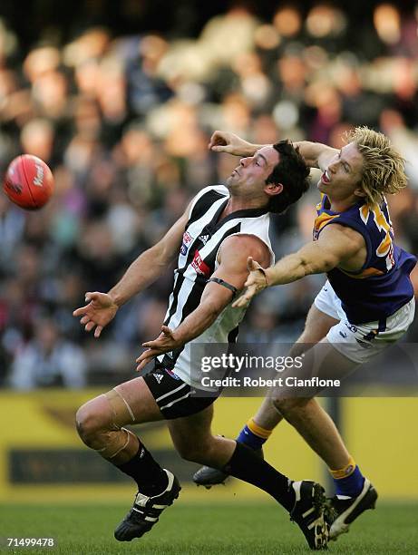 Alan Didak of the Magpies is challenged by Adam Selwood of the Eagles during the round 16 AFL match between the Collingwood Magpies and the West...