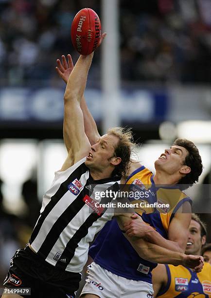 Josh Fraser of the Magpies is challenged by Mark Seaby of the Eagles during the round 16 AFL match between the Collingwood Magpies and the West Coast...