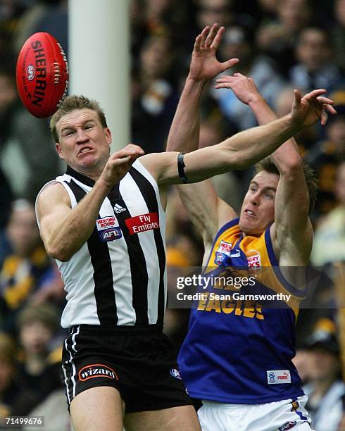 Nathan Buckley for Collingwood and Adam Selwood for the Eagles in action during the round 16 AFL match between the Collingwood Magpies and the West...