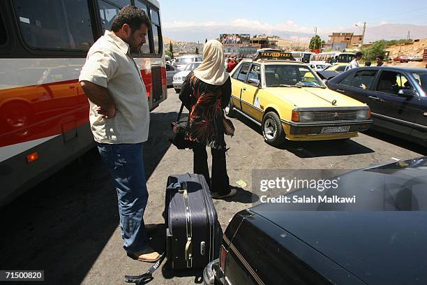 Lebanese people arrive to cross the border into neighboring Syria July 22, 2006 at al-Masnaa, Lebanon. Thousands of foreigners and Lebanese have fled...