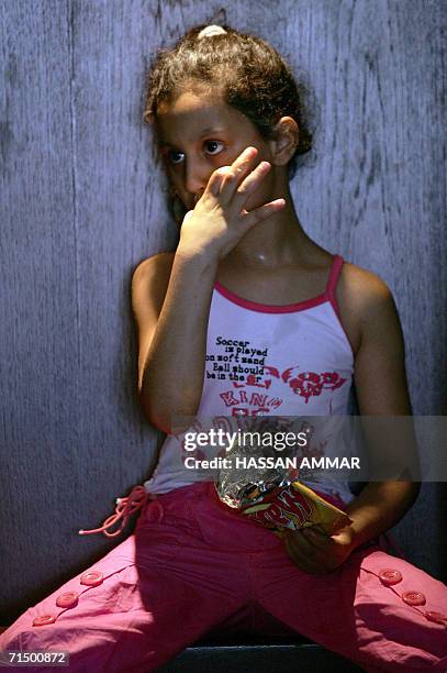 Lebanese girl displaced from a border village in south Lebanon eats on the floor at a hotel in the southern Lebanese port city of Tyre, 22 July 2006....