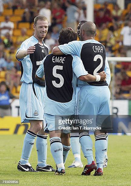 Emre of Newcastle is congratulated by Stephen Carr and Craig Moore after scoring the third goal during the UEFA Intertoto Cup third round Second leg...
