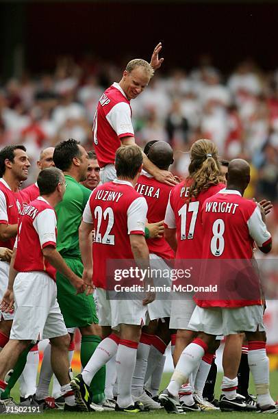 Dennis Bergkamp of Arsenal is carried aloft by teammates, following his final game during the Dennis Bergkamp testimonial match between Arsenal and...