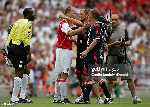 Dennis Bergkamp of Arsenal, is hugged by Ronald and Frank De Boer of Ajax, following his final game during the Dennis Bergkamp testimonial match...