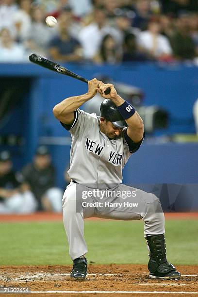 Jorge Posada of the New York Yankees ducks out of the way of a wild pitch by Ted Lilly of the Toronto Blue Jays during the second inning on July 22,...