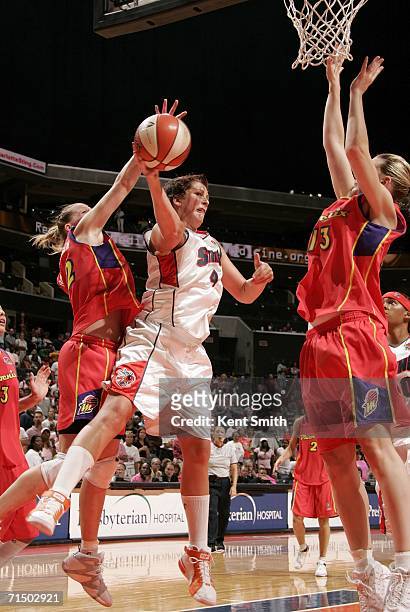 Janel McCarville of the Charlotte Sting drives to the basket and makes the pass against Penny Taylor of the Phoenix Mercury on July 22, 2006 at the...