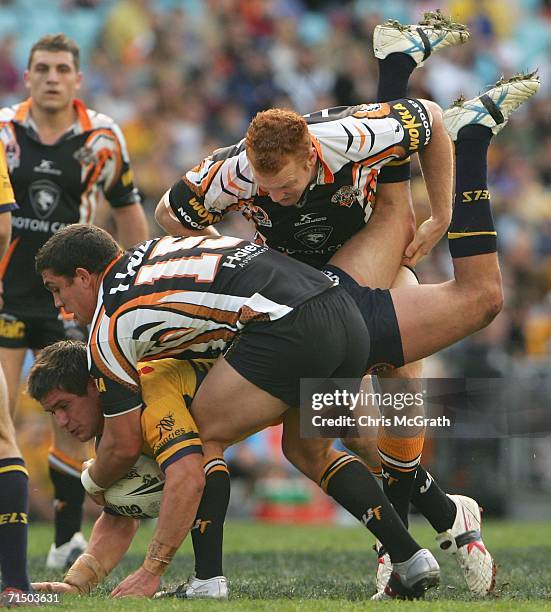 Josh Cordoba of the Eels is up ended by the Tigers defence during the round 20 NRL match between the Wests Tigers and the Parramatta Eels played at...