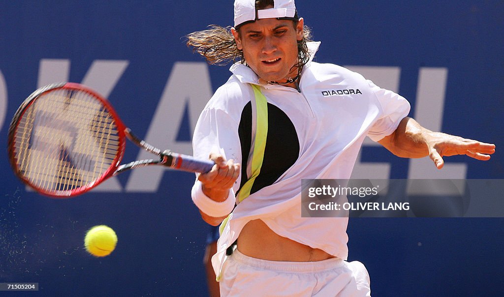 David Ferrer of Spain returns a shot to