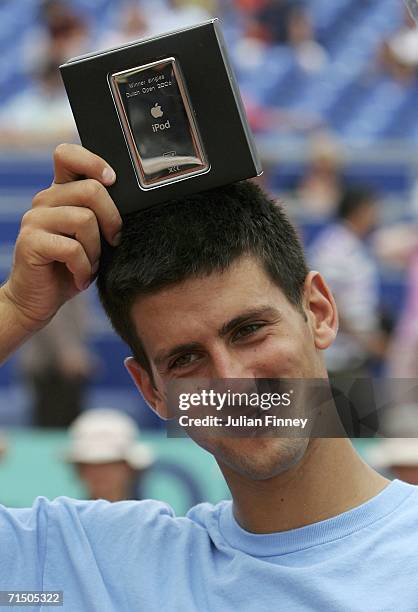 Novak Djokovic of Serbia & Montenegro celebrates defeating Nicolas Massu of Chile in straight sets with his prize - an ipod after the final during...
