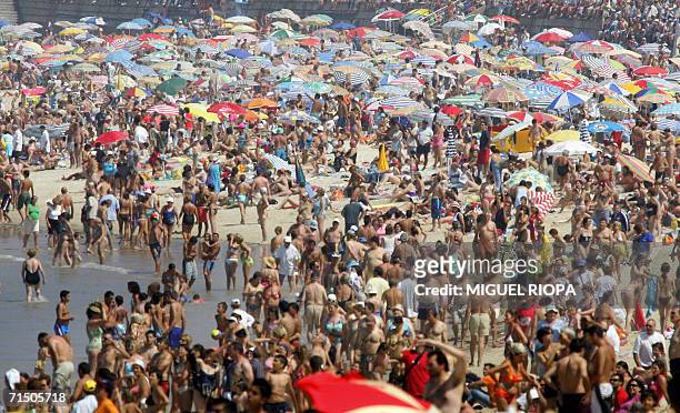 Crowds are seen on Samil beach in Vigo, 23 July 2006. Much of Europe benefited Sunday from a return to cooler weather but forecasters said the...