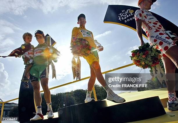 Yellow jersey USA's Floyd Landis celebrates with red-and-white polka dotted jersey Denmark's Michael Rasmussen and green jersey Australia's Robbie...