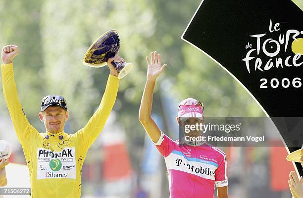 Andreas Kloeden of Germany and T-Mobile celebrates his second place as Floyd Landis of the USA and Phonak celebrates with the yellow jersey as...