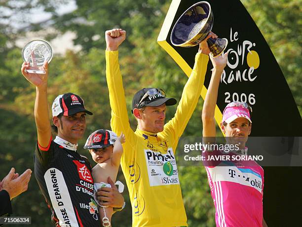 Yellow jersey USA's Floyd Landis celebrates with second placed overall Germany's Andreas Kloden and Spain's Oscar Pereiro Sio on the winners' podium...