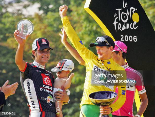 Yellow jersey USA's Floyd Landis celebrates with second placed overall Germany's Andreas Kloden and Spain's Oscar Pereiro Sio on the winners' podium...