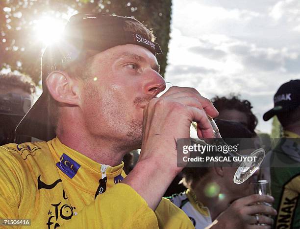 Yellow jersey USA's Floyd Landis drinks champain to celebrate his victory after the 154.5 km twentieth and last stage of the 93rd Tour de France...