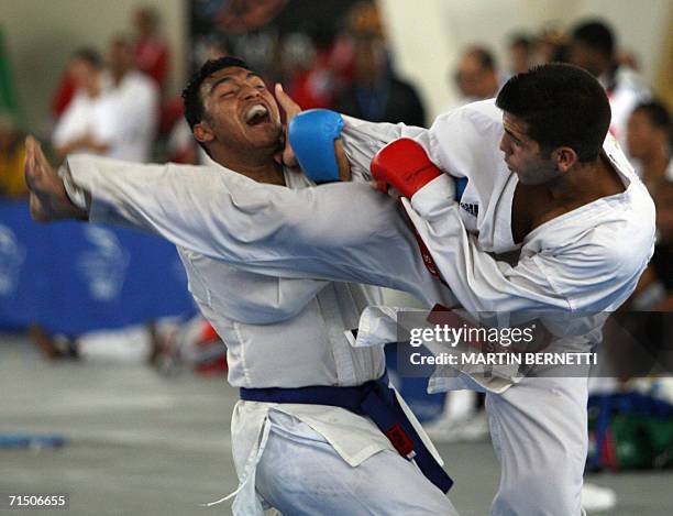 El karateca Midiet Roque de Cuba aplica una patada a su contrincante colombiano Francisco Cifuentes durante la pelea de karate Do Kumite categoria...