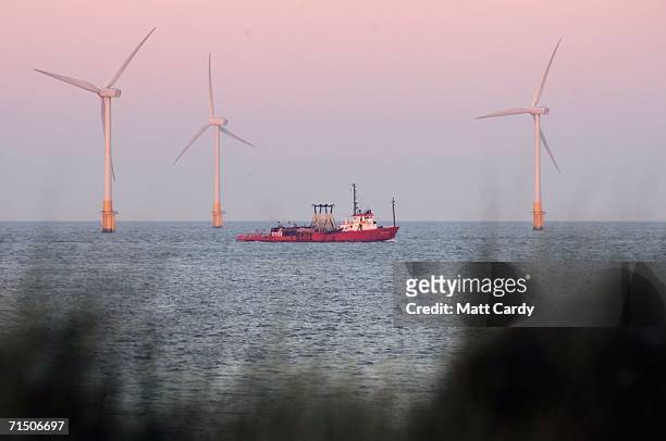 Boat passes infront of Britain's largest offshore wind farm off the Great Yarmouth coastline on July 19, 2006 in Norfolk, England. The 30 turbines...