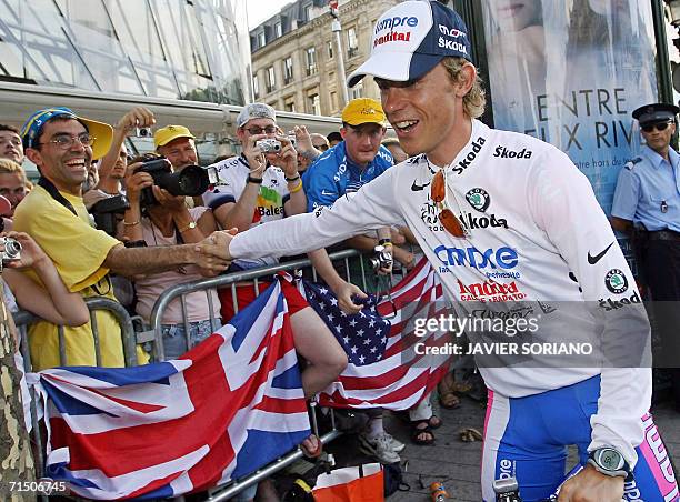 Italy's Damiano Cunego is congratulated by supporters after he celebrated the white jersey of best young rider on the podium of the 154.5 km...