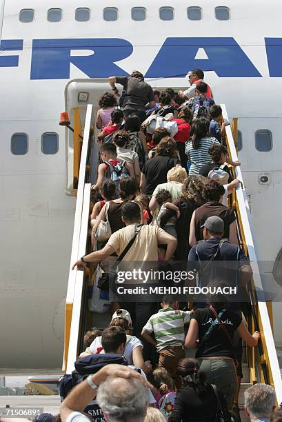 Passengers board an Air France 747 at the airport in Nicosia 22 July 2006 to be repartiated to Paris after being evacuated from Beirut. The French...