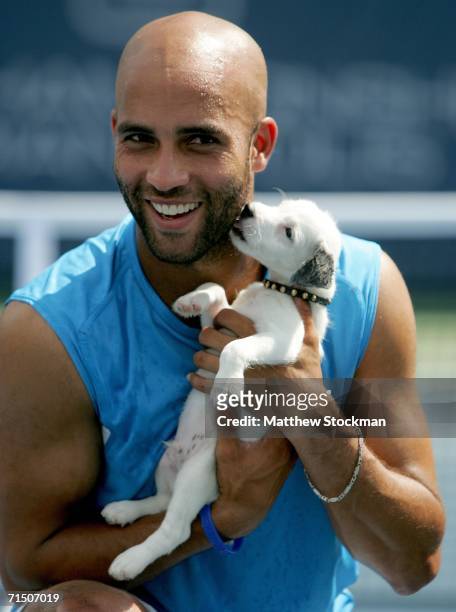 James Blake poses for photographers with Chipper after his victory over Andy Roddick during the RCA Championships July 23, 2006 at the Indianapolis...