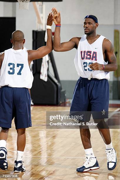 LeBron James gives a high five to Chris Paul during USA Senior Mens National Team practice on July 23, 2006 at the Cox Pavilion in Las Vegas, Nevada....