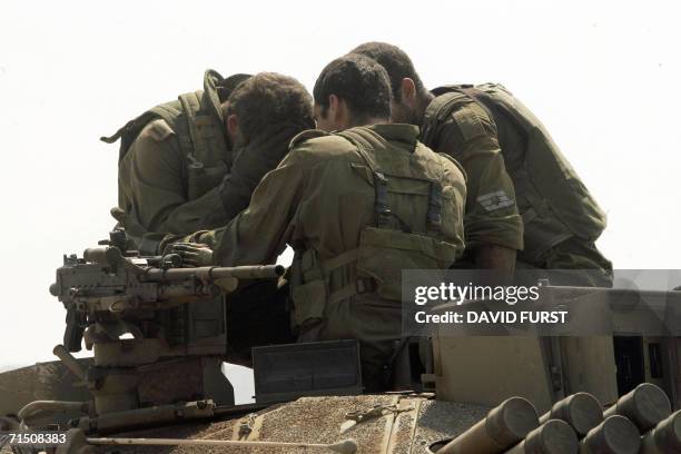 Israel-Lebanon border, ISRAEL: Israeli soldiers comfort each other after crossing the border back into Israel after an incursion inside southern...