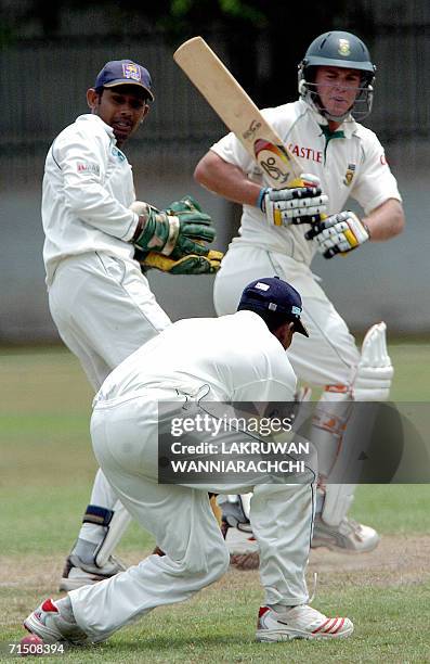 South African cricketer A B de Villiers watches Sri Lankan cricketer Thilan Samaraweera drop a catch as Sri Lankan wicket-keeper Prasnna Jayawardene...